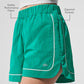 Motivate Track Shorts — Spruce Green/White